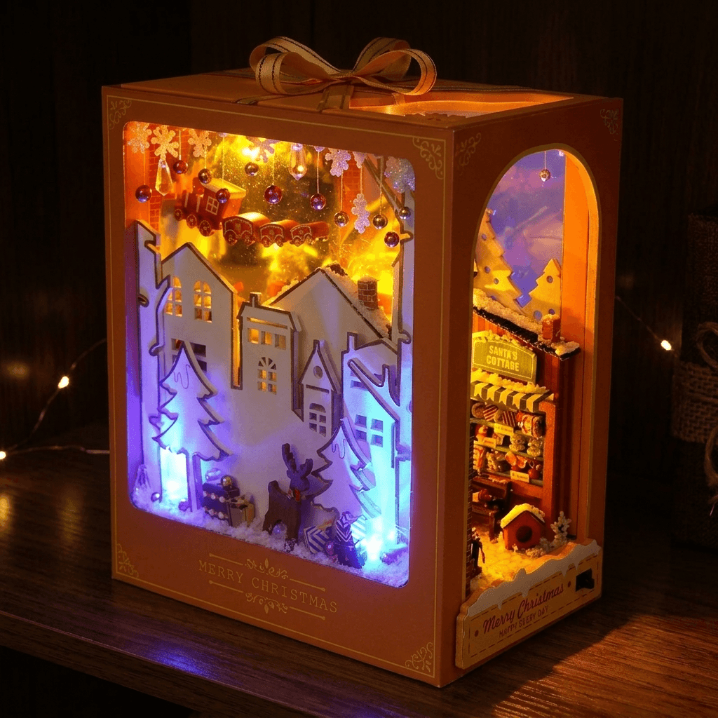The Christmas Village book nook glowing in a dark room
